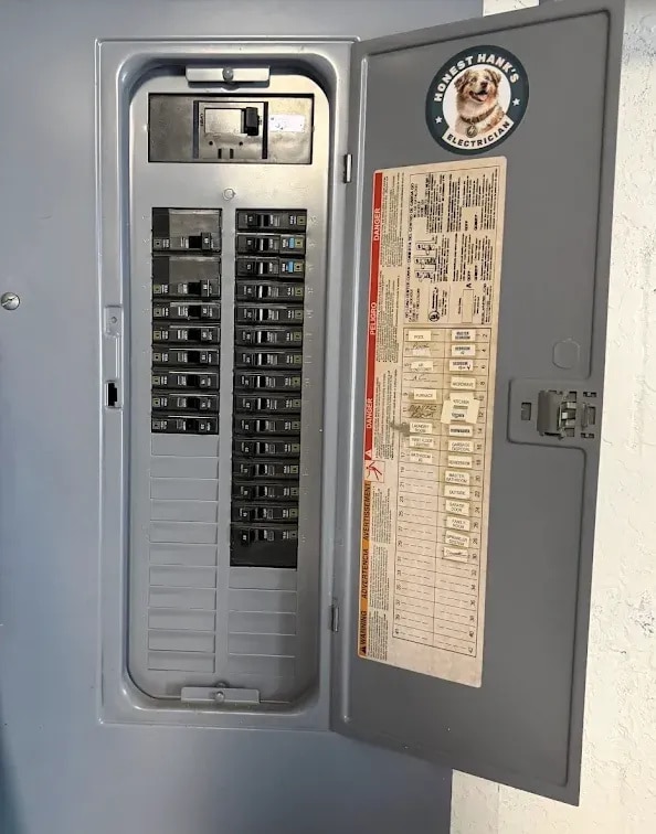 Licensed electrician inspecting an electrical panel on a commercial building in Tampa